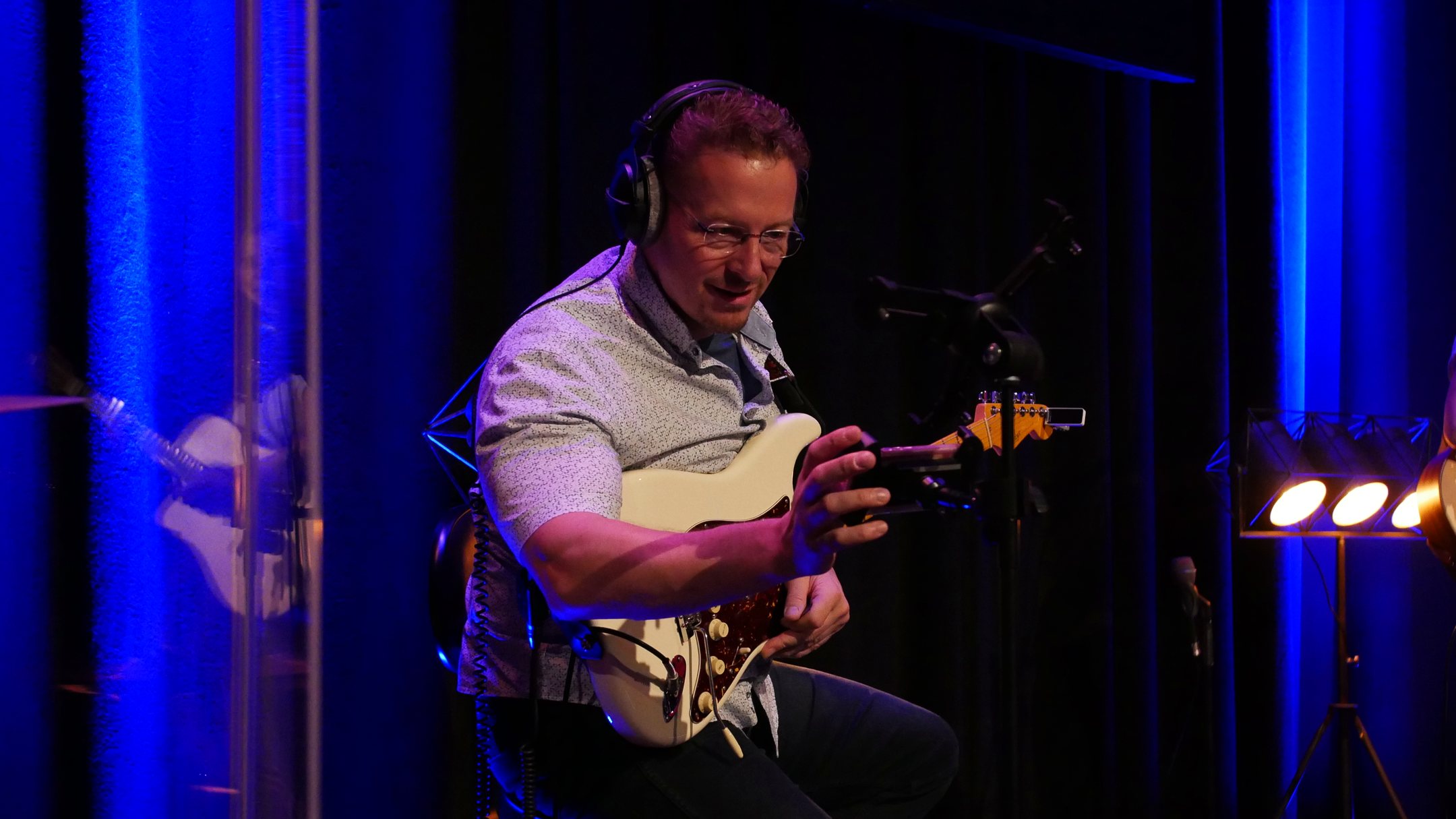 Alexander Stakenburg playing electric guitar on stage